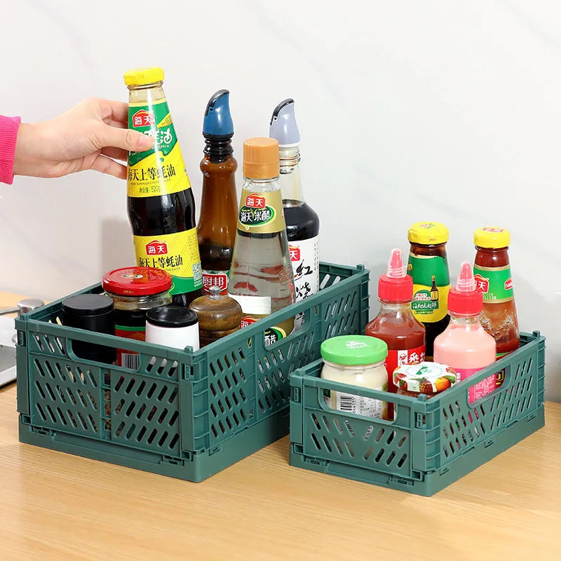 Green foldable storage crates used for organizing condiments and pantry bottles