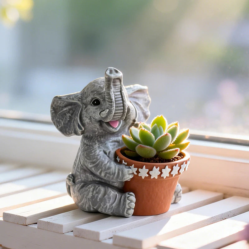 Gray resin elephant-shaped planter holding a potted succulent on a windowsill
