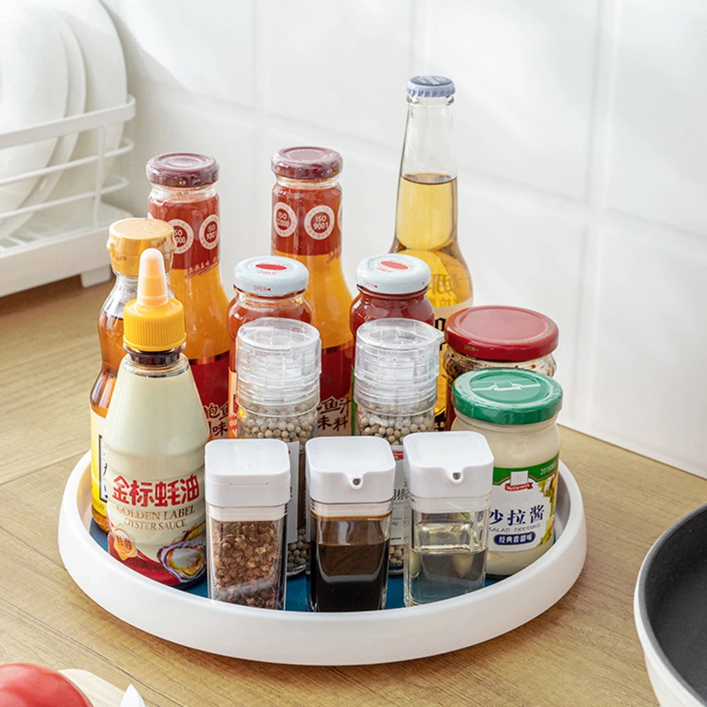 Rotating kitchen turntable organizer holding various sauces and spice jars on countertop