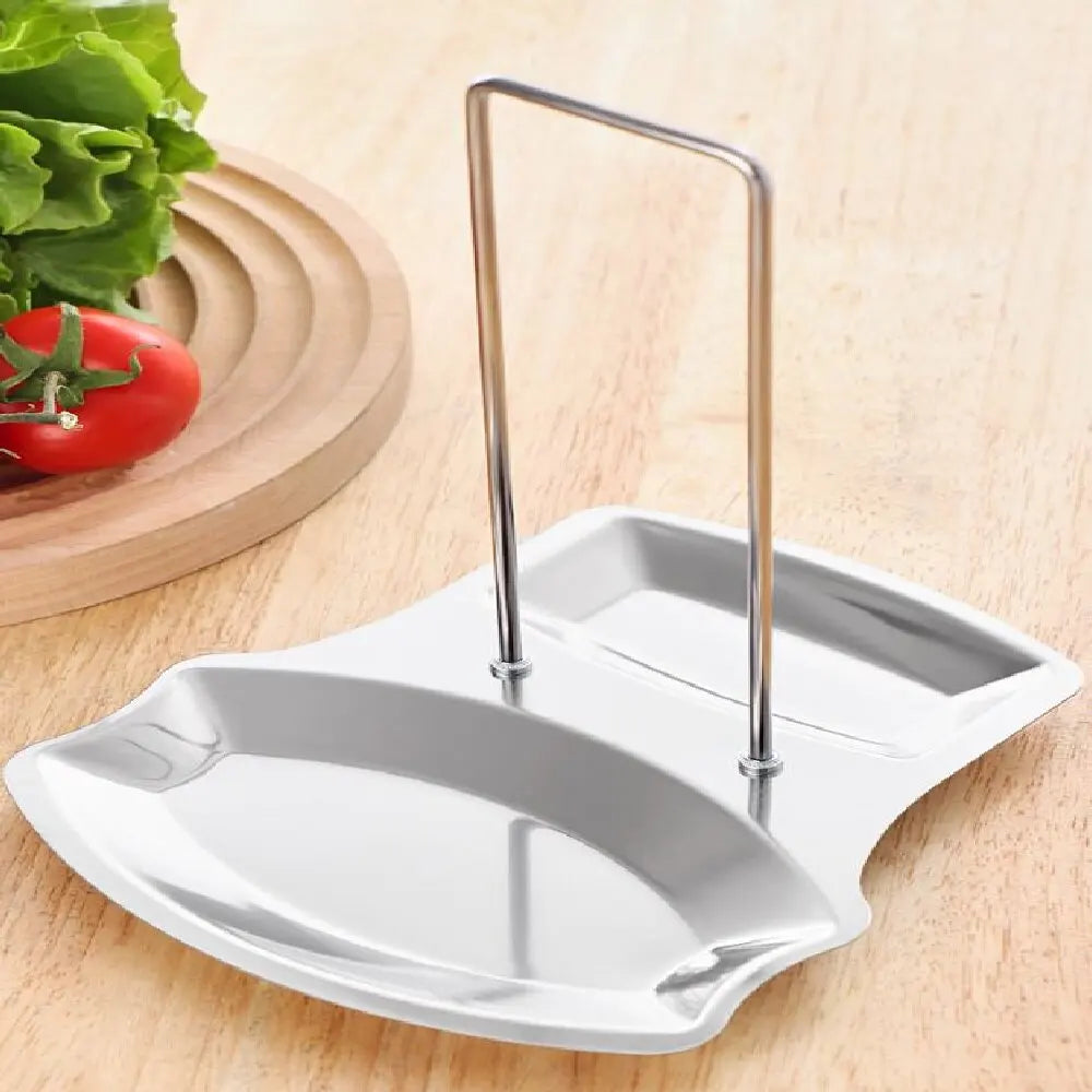 Empty stainless steel pot lid and utensil rest on kitchen counter with vegetables nearby