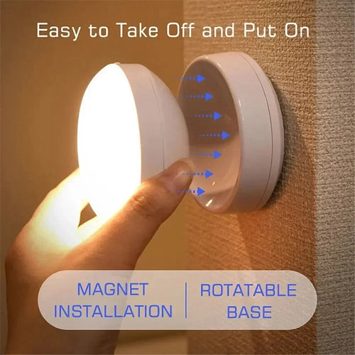 Person removing a round magnetic night light with a glowing LED base from a wall mount