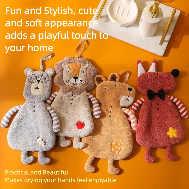 Four cute animal-shaped hanging hand towels displayed on an orange surface beside bathroom accessories