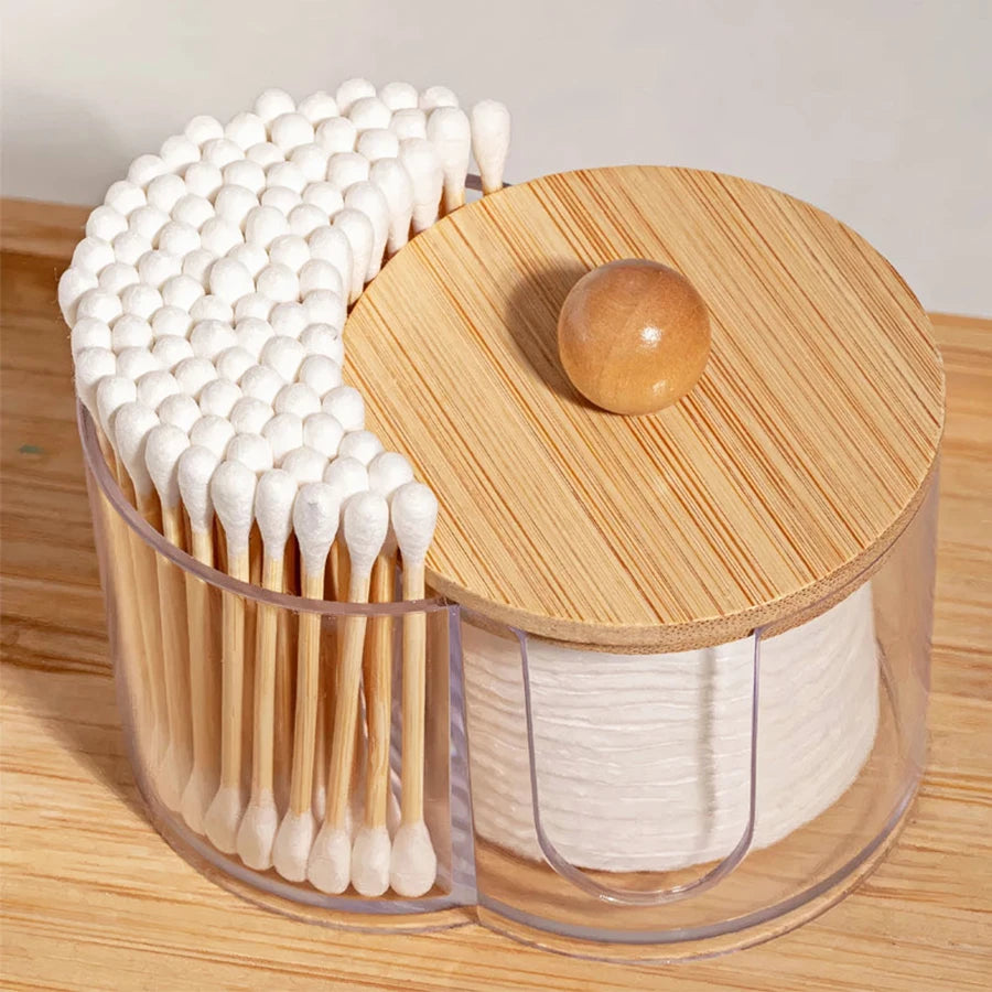 Overhead view of cotton swab and pad organizer with wooden lid on wood surface
