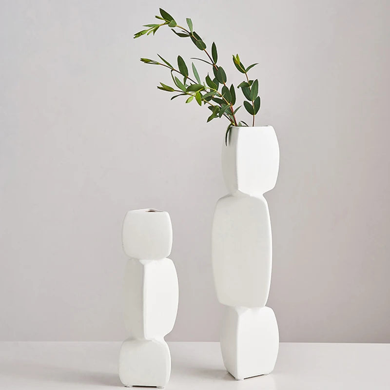 Tall white geometric minimalist ceramic vase and shorter version shown side by side