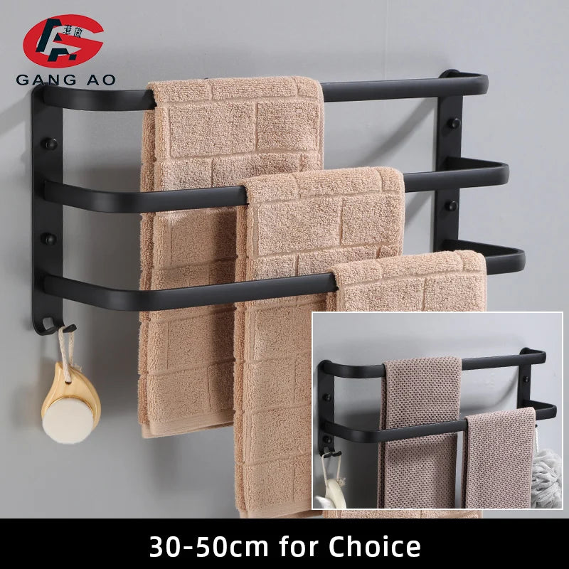 matte black three-bar towel rack with beige towels and hanging hook, shown on bathroom wall