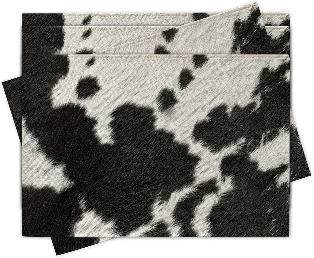 Black and white cowhide print linen placemats, rectangular set stacked on table