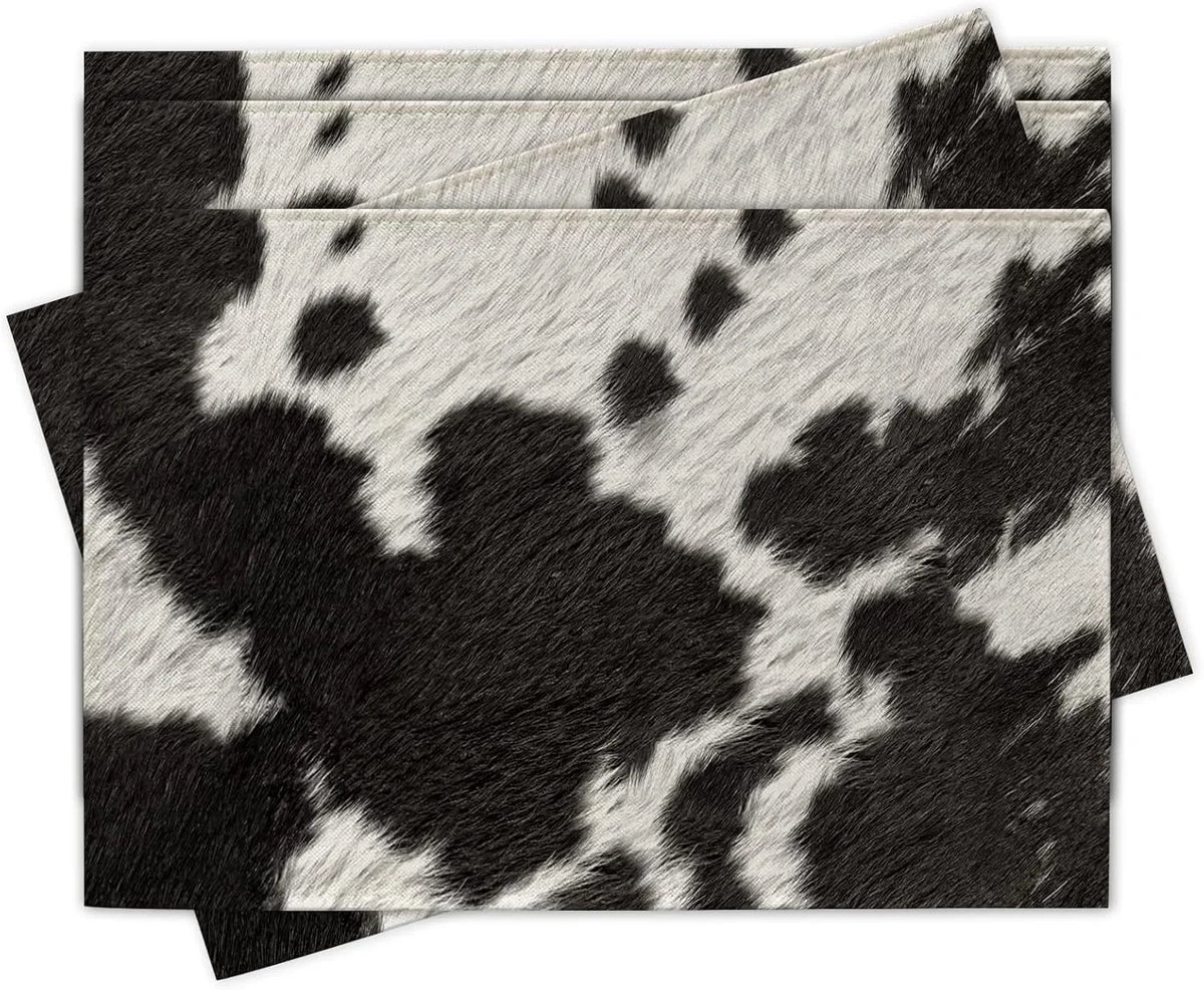 Black and white cowhide print linen placemats, rectangular set stacked on table