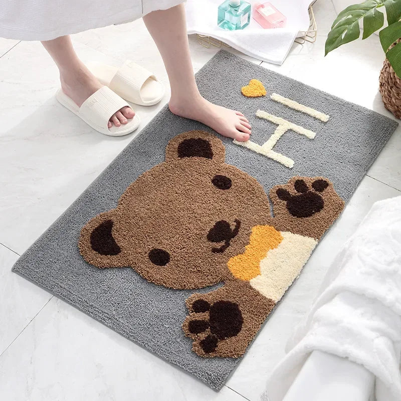 Bear cartoon microfiber bath mat in a bathroom, foot in white slipper nearby