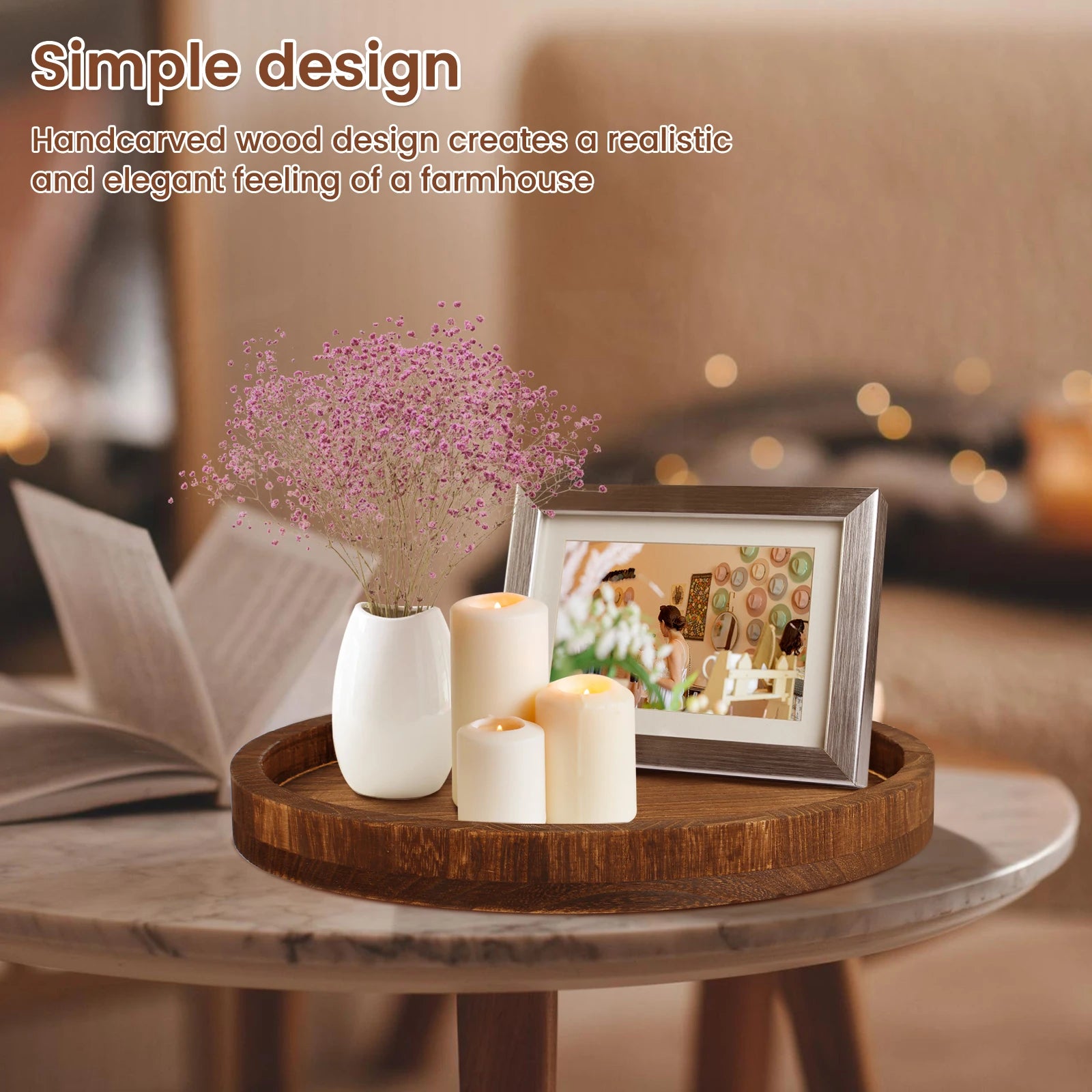 Round wooden tray styled on coffee table with candles, vase, and photo frame