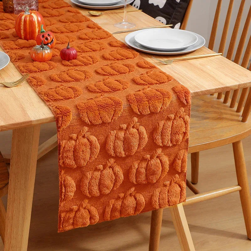 pumpkin embossed orange table runner on wood dining table with fall decor
