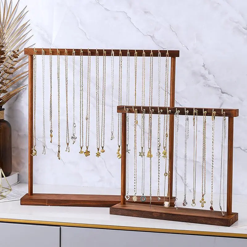 side-by-side wood jewelry stands holding multiple necklaces and chains