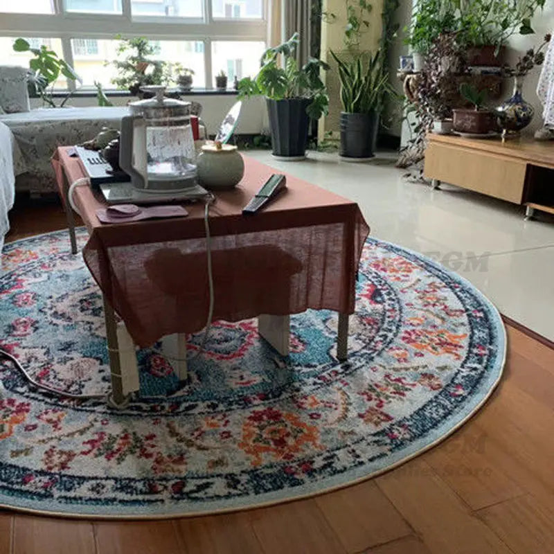 Round printed area rug under a coffee table in a cozy, plant-filled living space