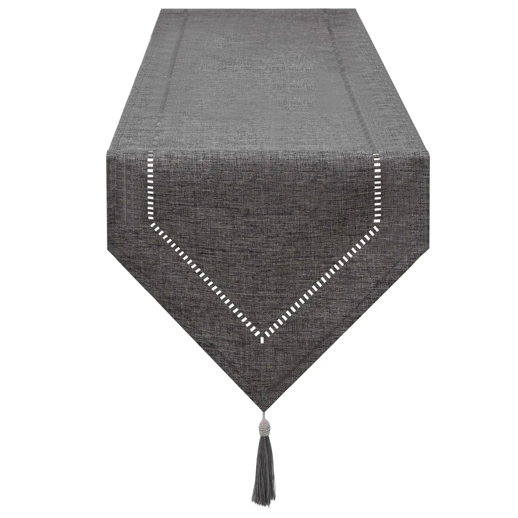solid gray linen table runner with white stitched border and tassel end