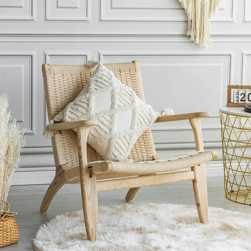 Tufted cotton pillow cover with geometric tufting displayed on an accent chair