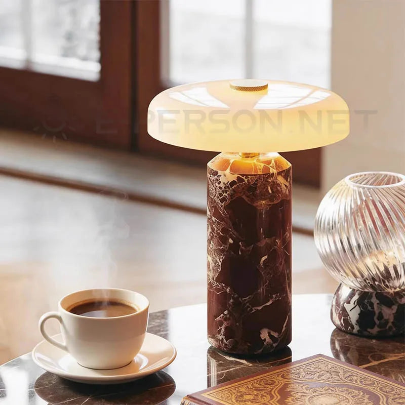 Marble table lamp on living room table beside coffee and book