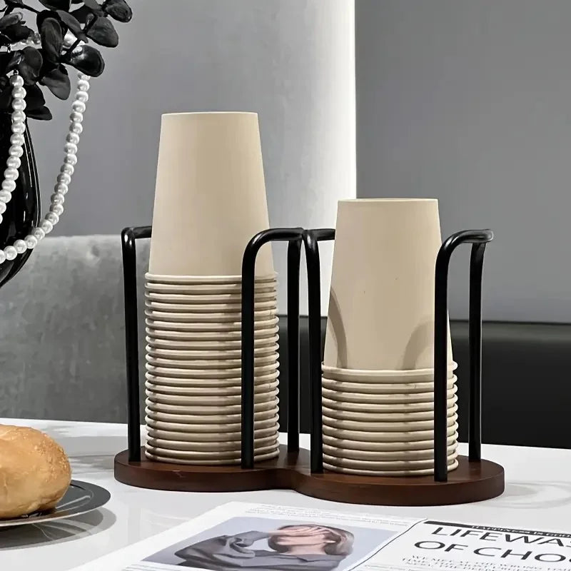 Double-compartment wood cup organizer with paper cups on a counter