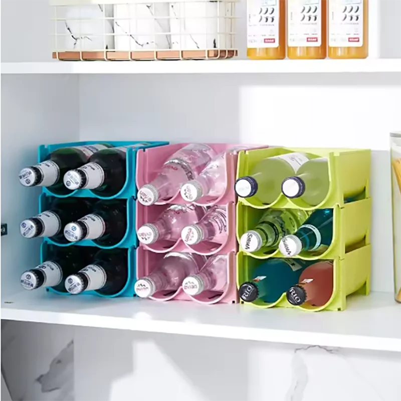 blue, pink, and green stackable bottle organizer racks with bottles arranged neatly inside a refrigerator shelf