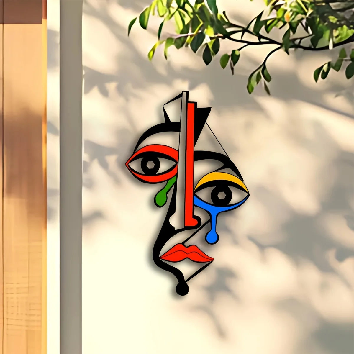 Modern geometric metal face wall art sculpture with bold colors in a bright indoor setting