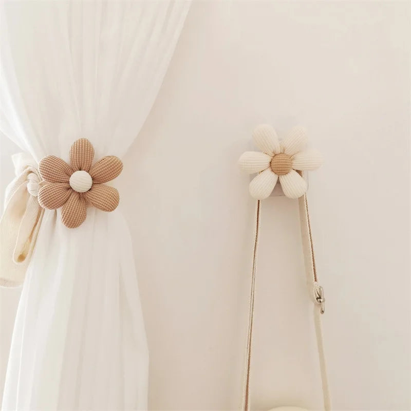Beige and khaki flower hooks on wall and curtain, shown in kids nursery decor setting