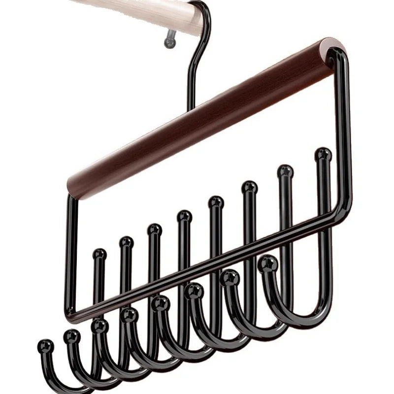 Close-up of the wooden hat organizer rack showing its wood bar and black metal hooks