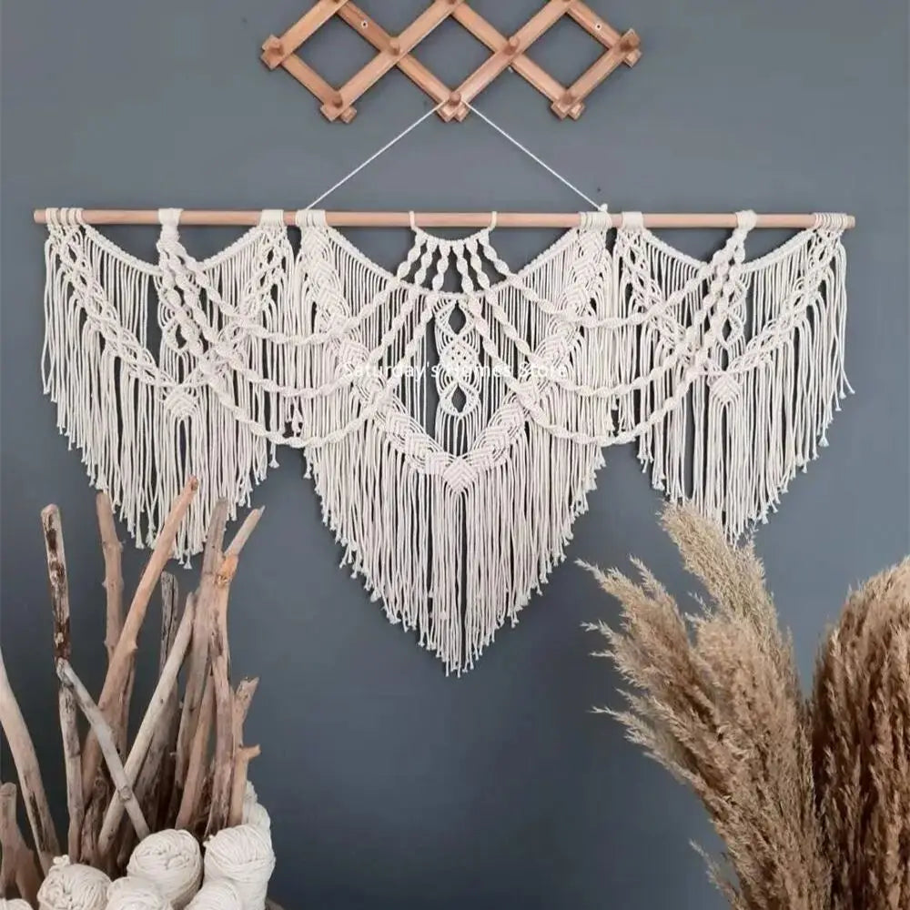 boho style macrame wall tapestry hanging above natural decor on grey wall