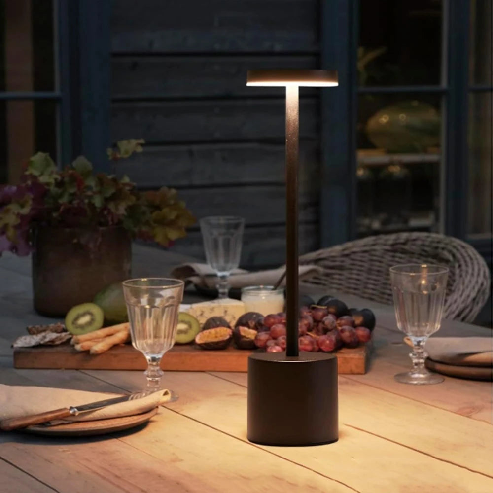 Rechargeable table lamp used outdoors on a wooden dining table