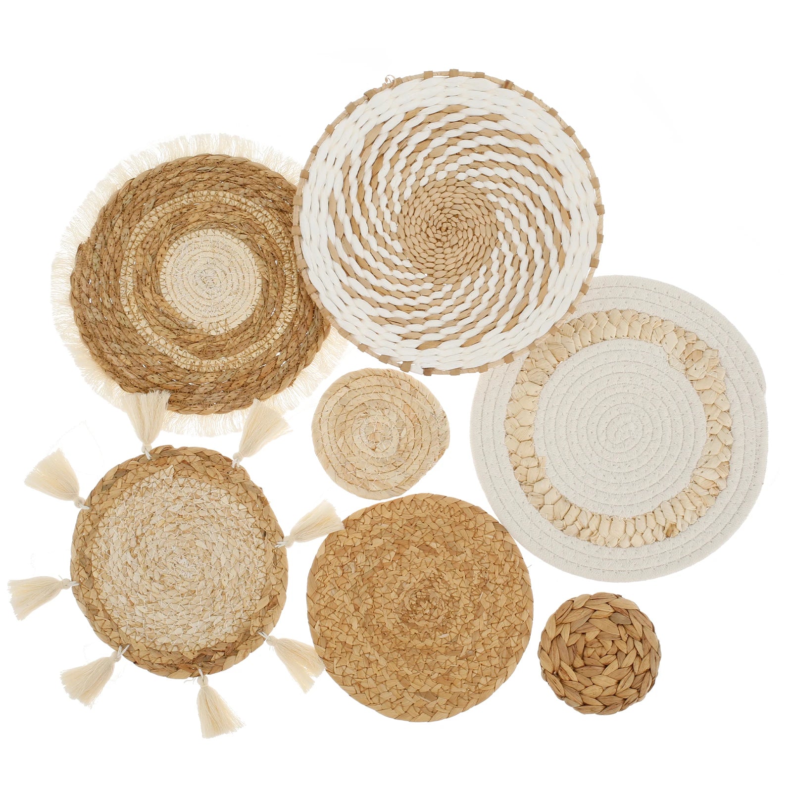 Seven handwoven rattan and wicker wall baskets, assorted natural patterns on a white background