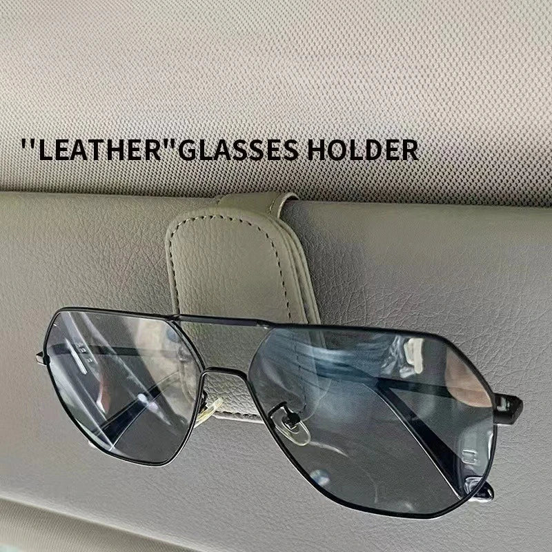 PU leather car glasses holder clip attached to sun visor with sunglasses hanging