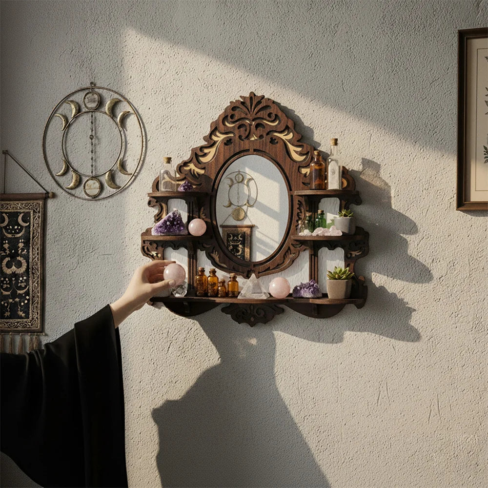 Hand placing a crystal on a gothic mirror display shelf with multiple wooden tiers
