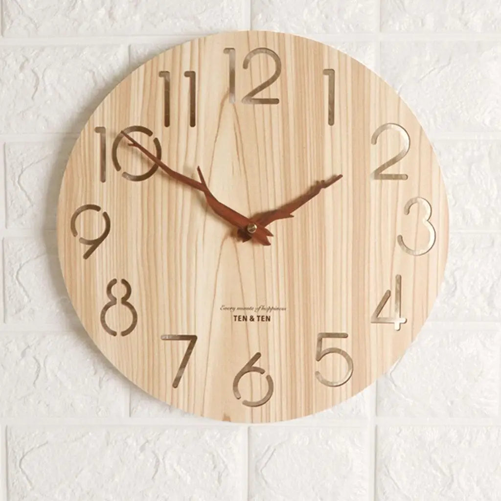 Wooden wall clock with clear white numbers hanging on a white textured wall