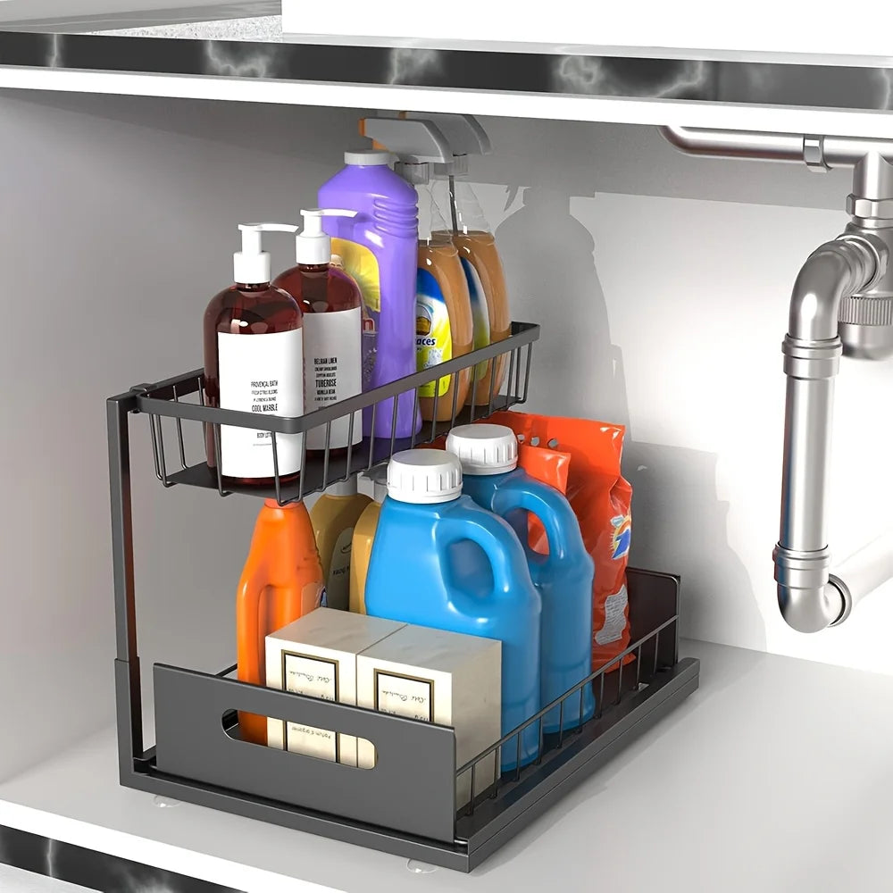 Black 2-tier under-sink sliding organizer with laundry products and soaps in a cabinet