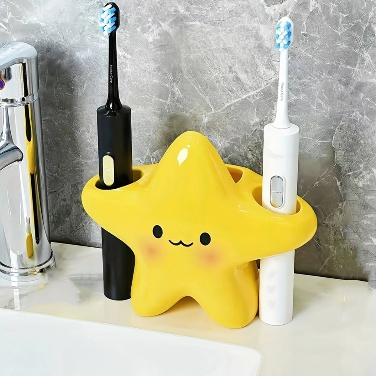Yellow star toothbrush holder organizing black and white electric toothbrushes beside a sink