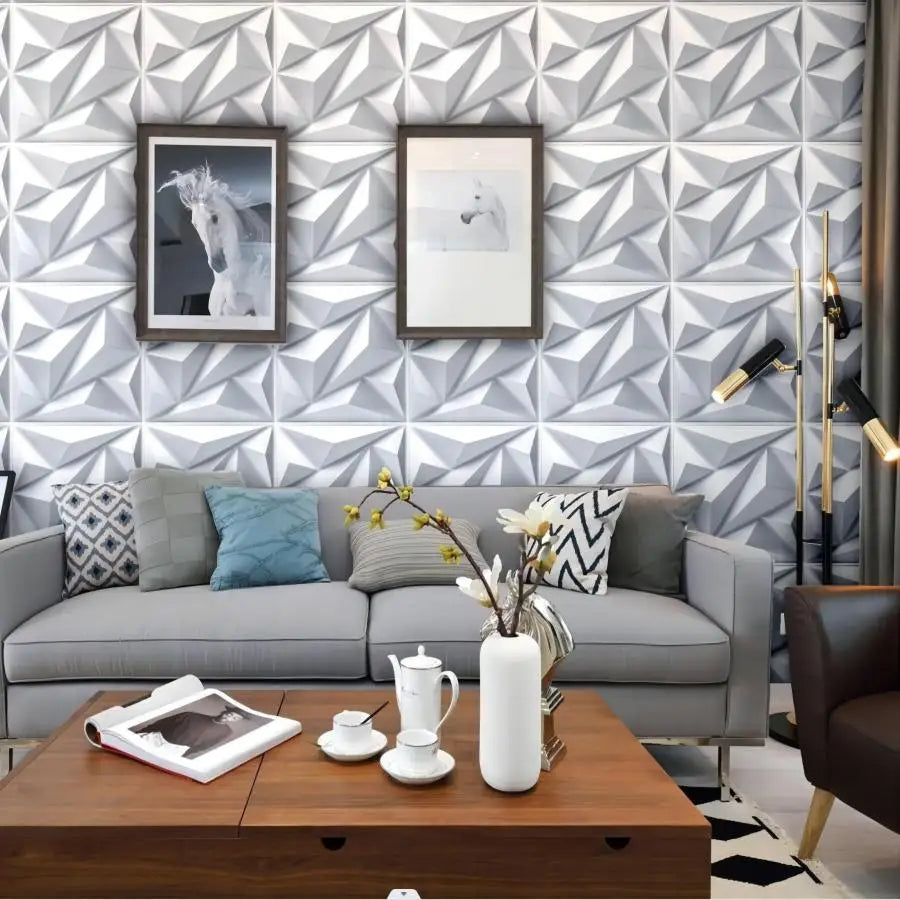 Modern living room with white geometric 3D wall panels as a feature wall behind a sofa and framed art