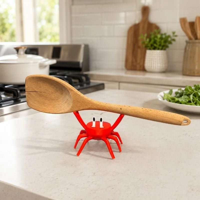 Red crab kitchen spoon holder used next to a stovetop