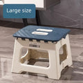 folding step stool with blue non-slip top and handle shown in living space