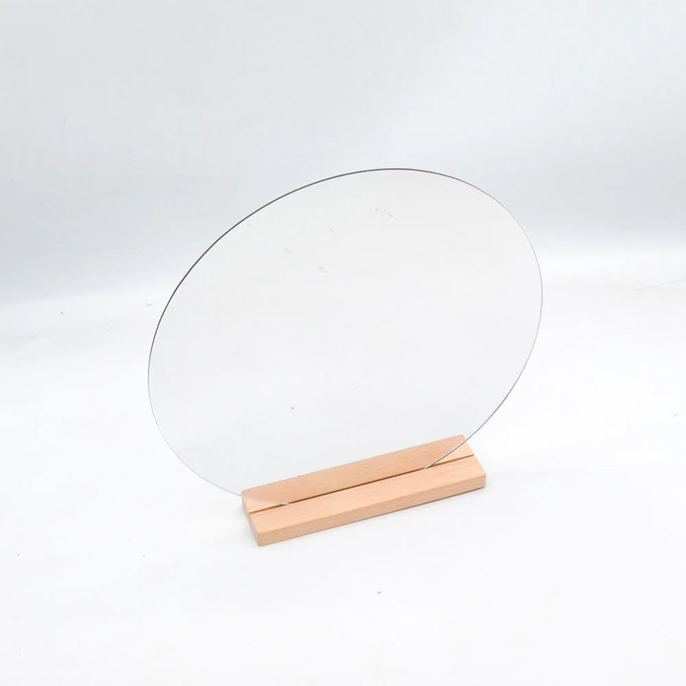 oval-shaped acrylic mirror on wood base for tabletop use