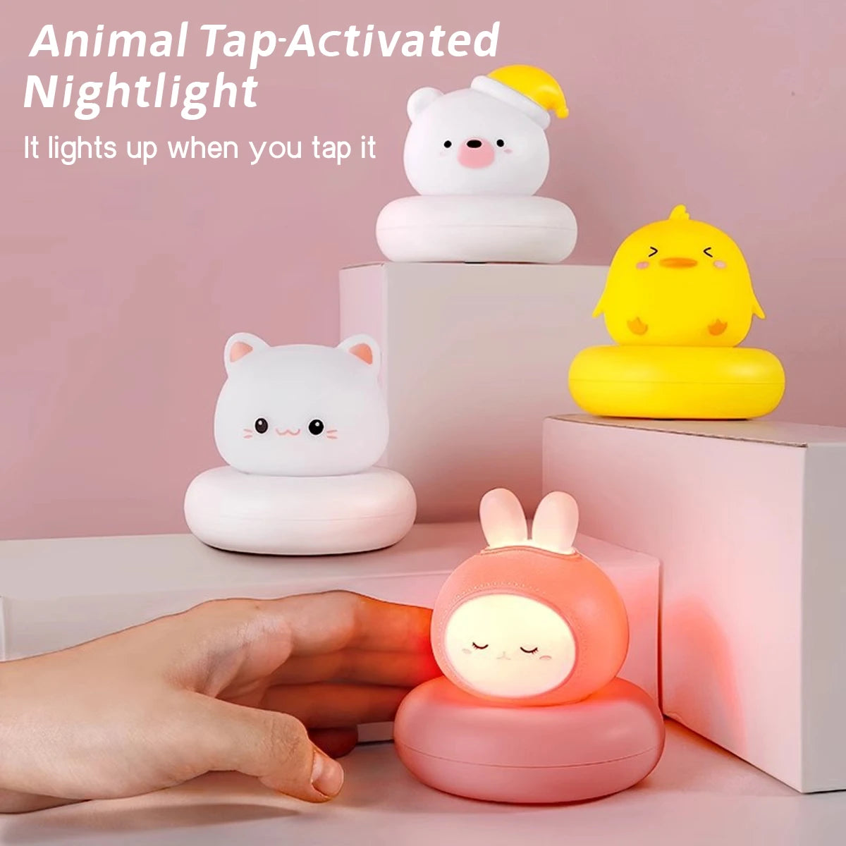 Hand tapping rabbit animal night light to turn it on, with bear, cat, and duck lights nearby