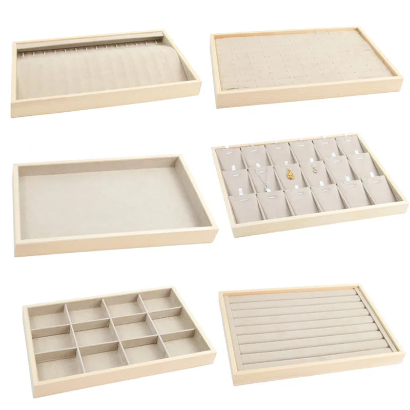 Collection of velvet-lined jewelry trays showing options for rings, necklaces, empty trays, and multiple compartment layouts