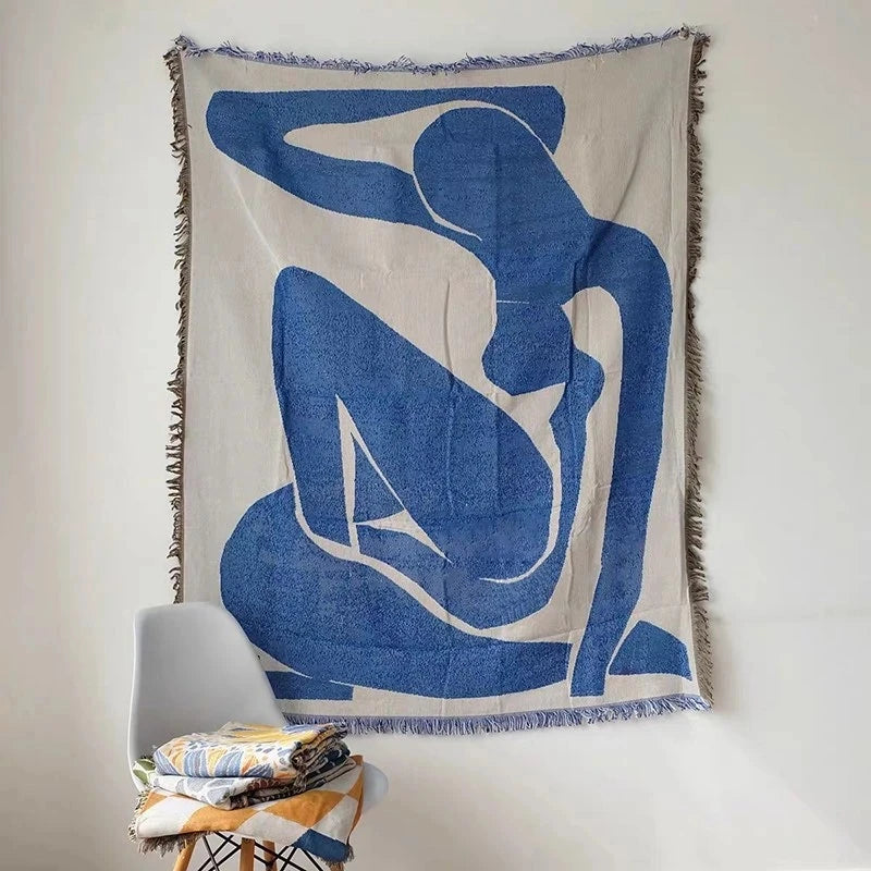 Abstract blue geometric woven blanket displayed as wall tapestry
