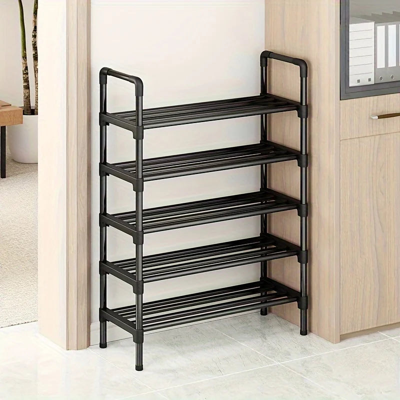 Narrow black five-tier shoe rack beside a cabinet in a home entryway