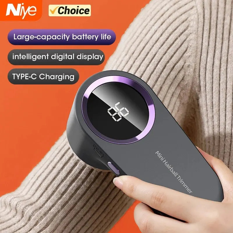 Grey rechargeable fabric lint remover with LED display in use on sweater sleeve