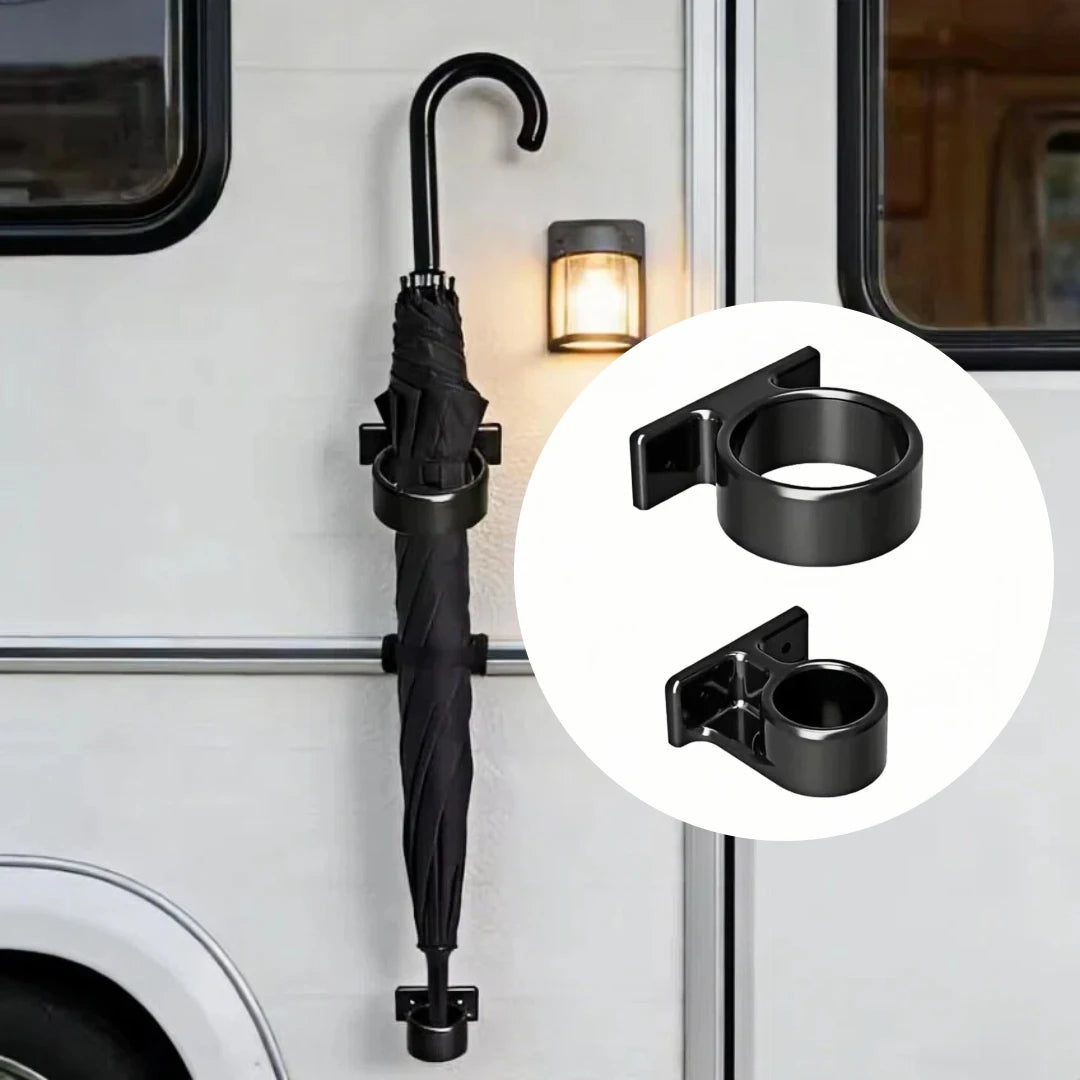 Black wall-mounted umbrella stand holding a closed umbrella on an exterior wall