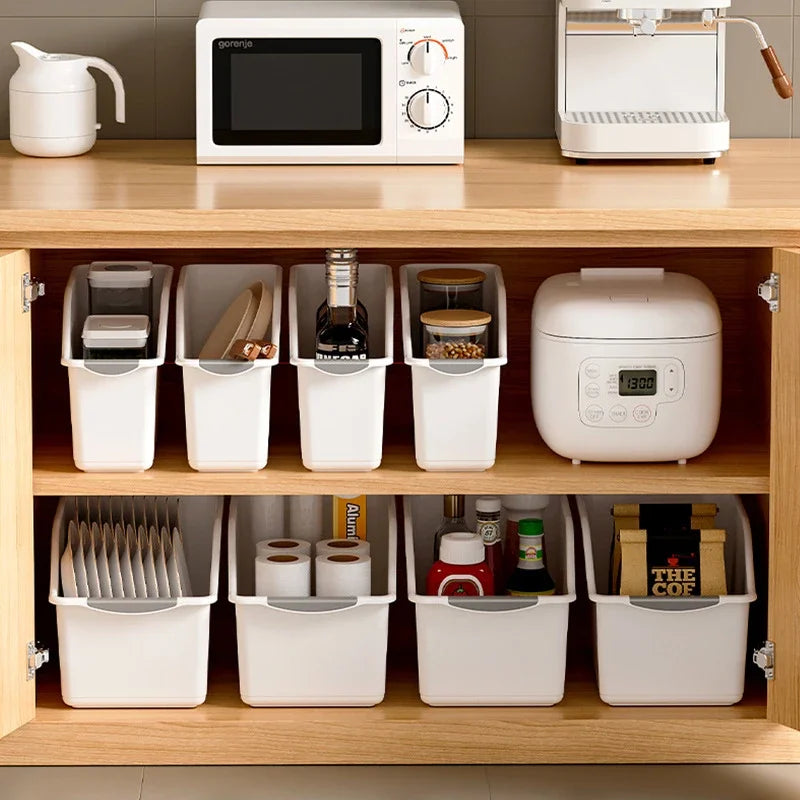 Multiple white curved plastic storage bins lined on cabinet shelves organizing various kitchen and household items