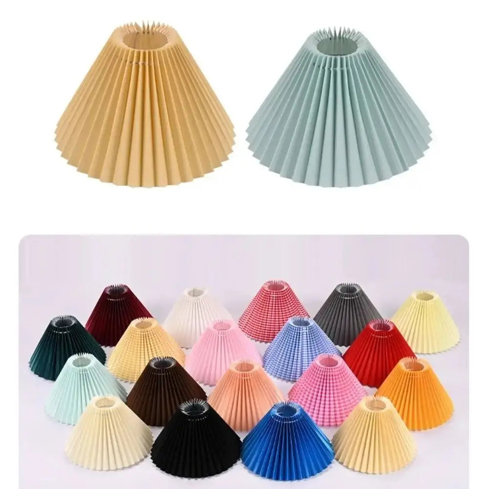Two pleated fabric lampshades in beige and light blue on white background