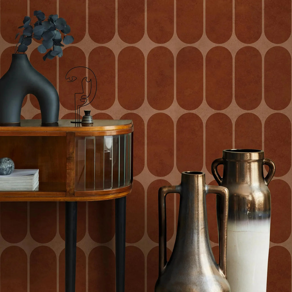 Geometric wallpaper in terracotta tones featured with wood console and metallic vases
