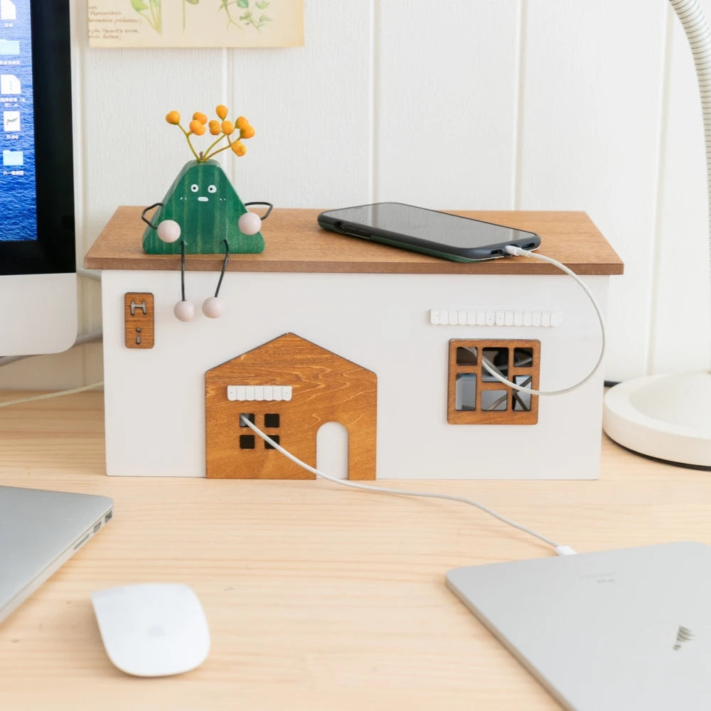 wooden cottage organizer box on workspace with phone charging cable