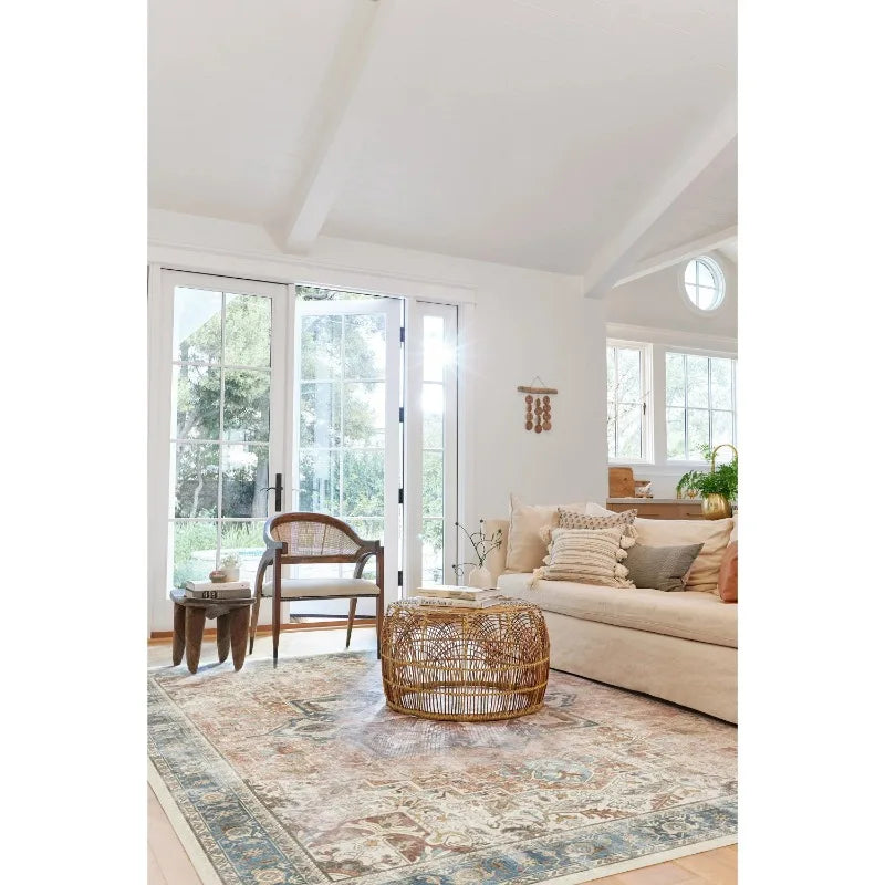 Living room with vintage geometric area rug under rattan coffee table