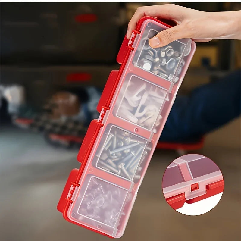 Hand holding a four-compartment plastic small parts organizer with screws inside