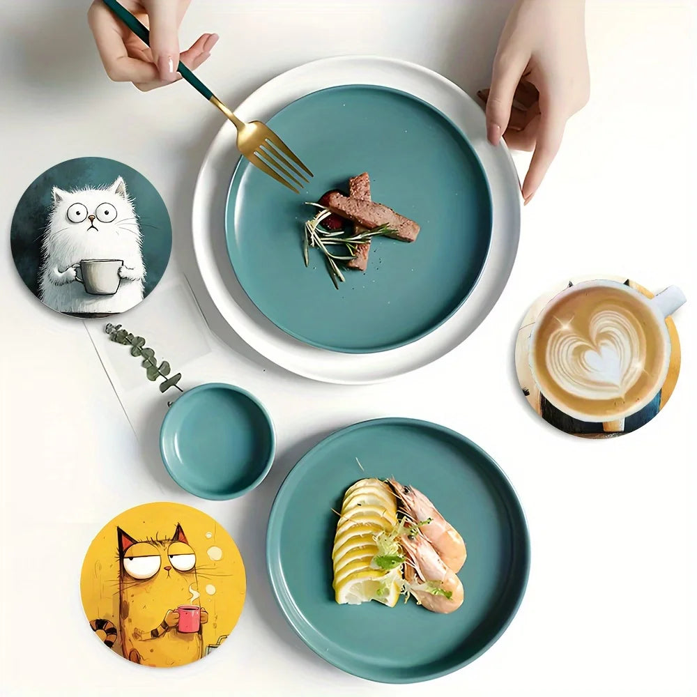 Cat coasters in use next to teal dinner plates and food for a cozy dining table setting