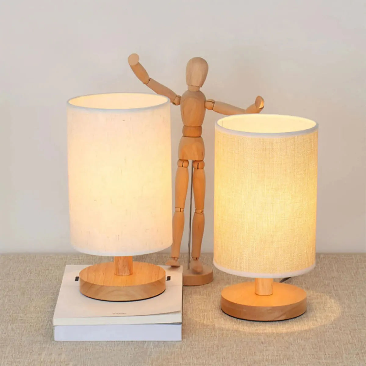 Two USB cylinder lamps, wood base, linen shades, with wooden mannequin for scale